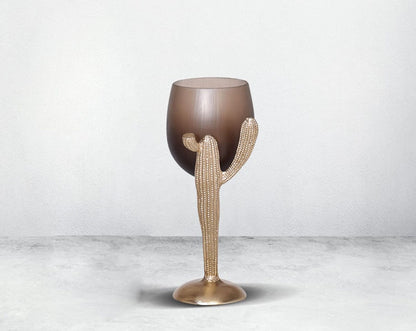 The pillar holder cactus design motif is crafted with green lustre glass with an antique gold finish aluminium decorative base.small