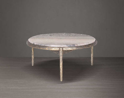 Round marble table with decorative legs on a dark background