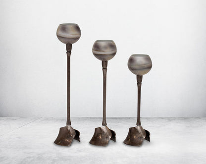 Pillar goblet candle holder in grey color and burnt glaze luster glass with nickel-plated textured aluminum decorative base.