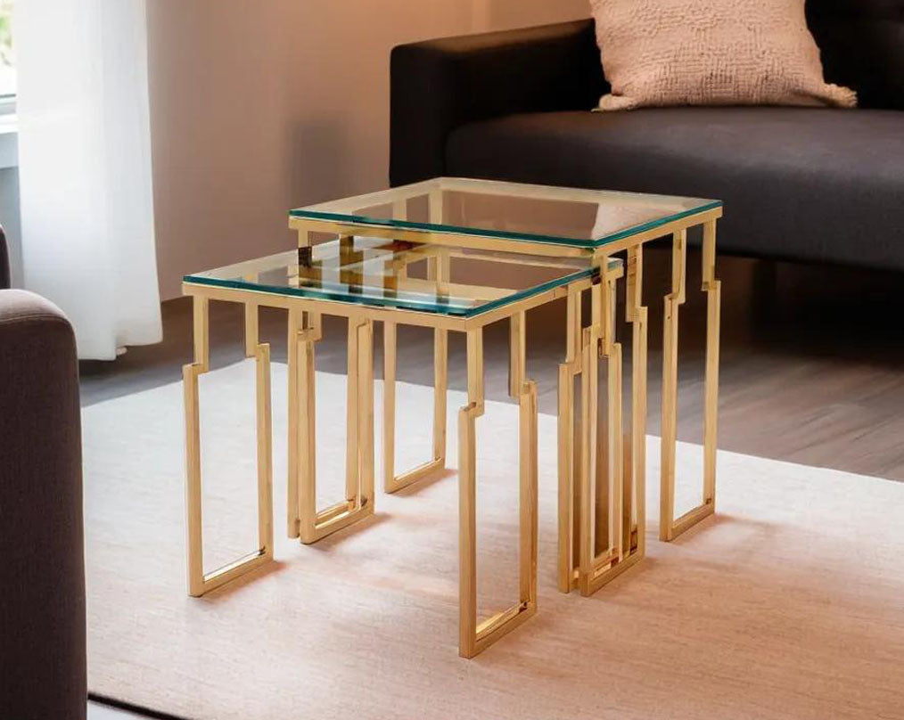 Nested tables in a set of 2 with clear tempered glass top and gold plated stainless steel base in rich contemporary design with living room