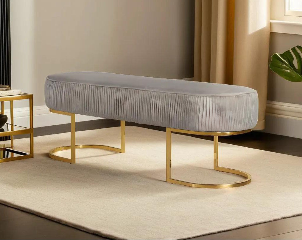 Double bench upholstered with tufted fabric seat and high polished gold plated stainless steel legs in classic design.