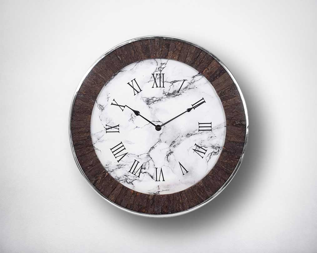 Round wall clock in nickel and rough wood in natural finish with roman numerals.