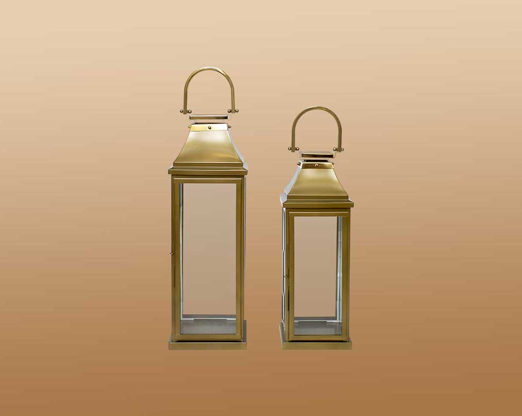 This lantern in modern classic style is crafted in Stainless steel finished in antique gold. It has clear glass & brass handles. This is a perfect mood setter enhancing any room with its glow. 1 large 2 small