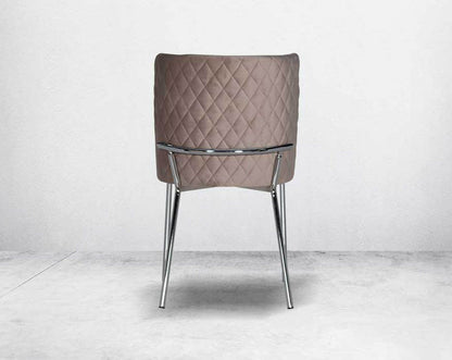 Minimalistically designed chair  back with criss-cross stitch padded fabric in silver finish stainless steel legs in contemporary design.
