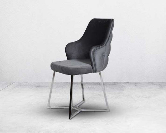 This soft, cushioned dining chair features an extraordinary contemporary design with a tufted back and cushioned seat with stainless steel legs side view