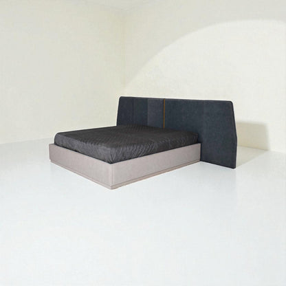 Modern bed with gray upholstered headboard on a white background