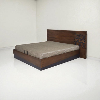 A modern wooden bed with a simple design, featuring a rectangular headboard with horizontal lines and a decorative geometric pattern on one side, placed in a minimal, white-walled room with a light-colored mattress.