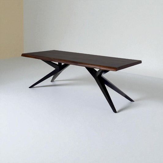 Wooden dining table with black metal legs on a white background