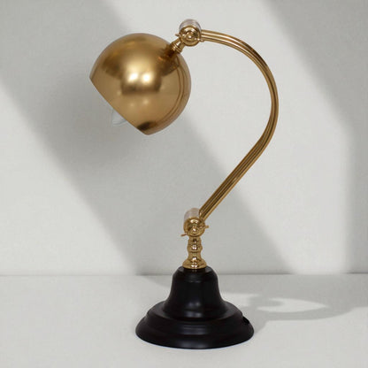 Gold and black desk lamp on a white background