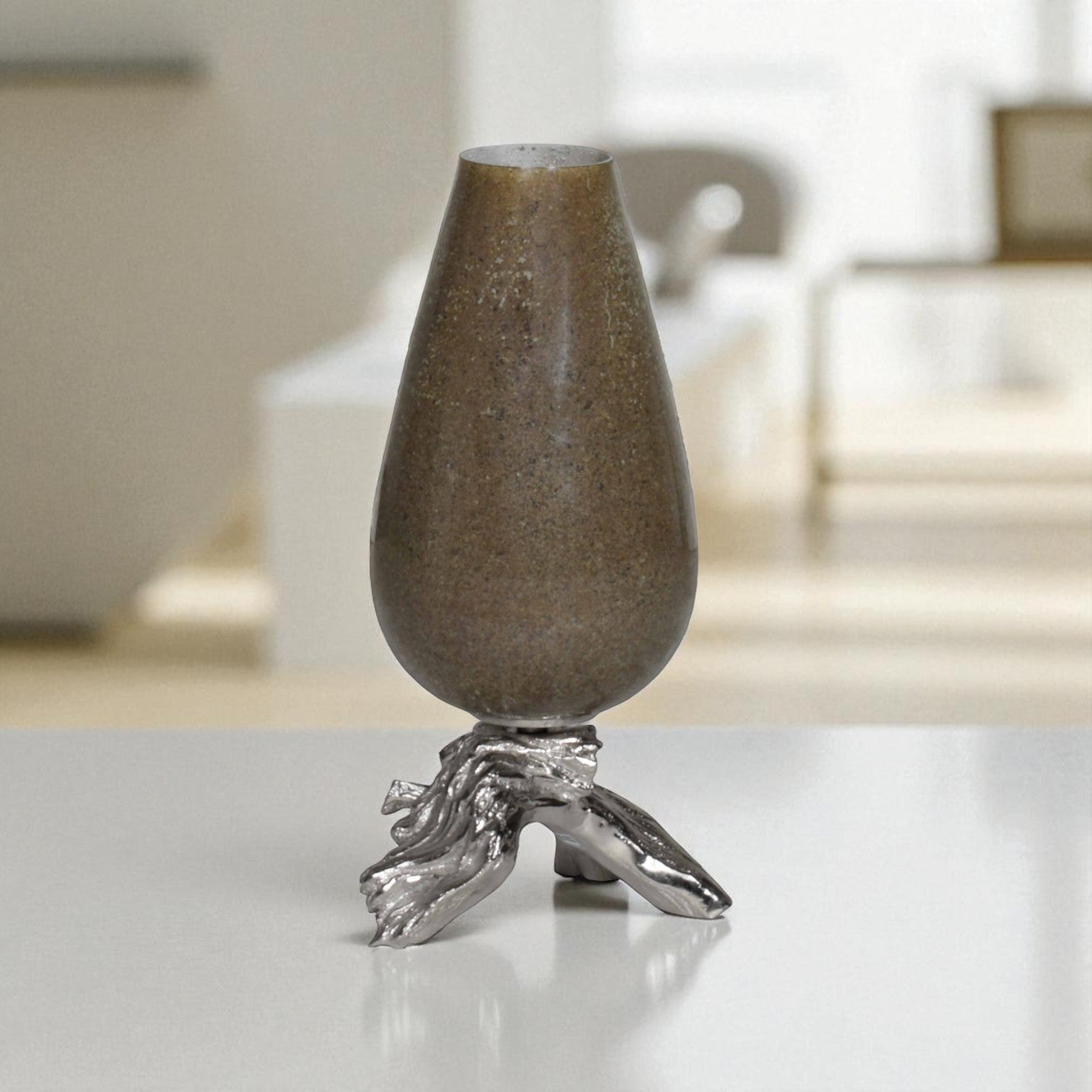 Decorative vase with a metallic base on a reflective surface