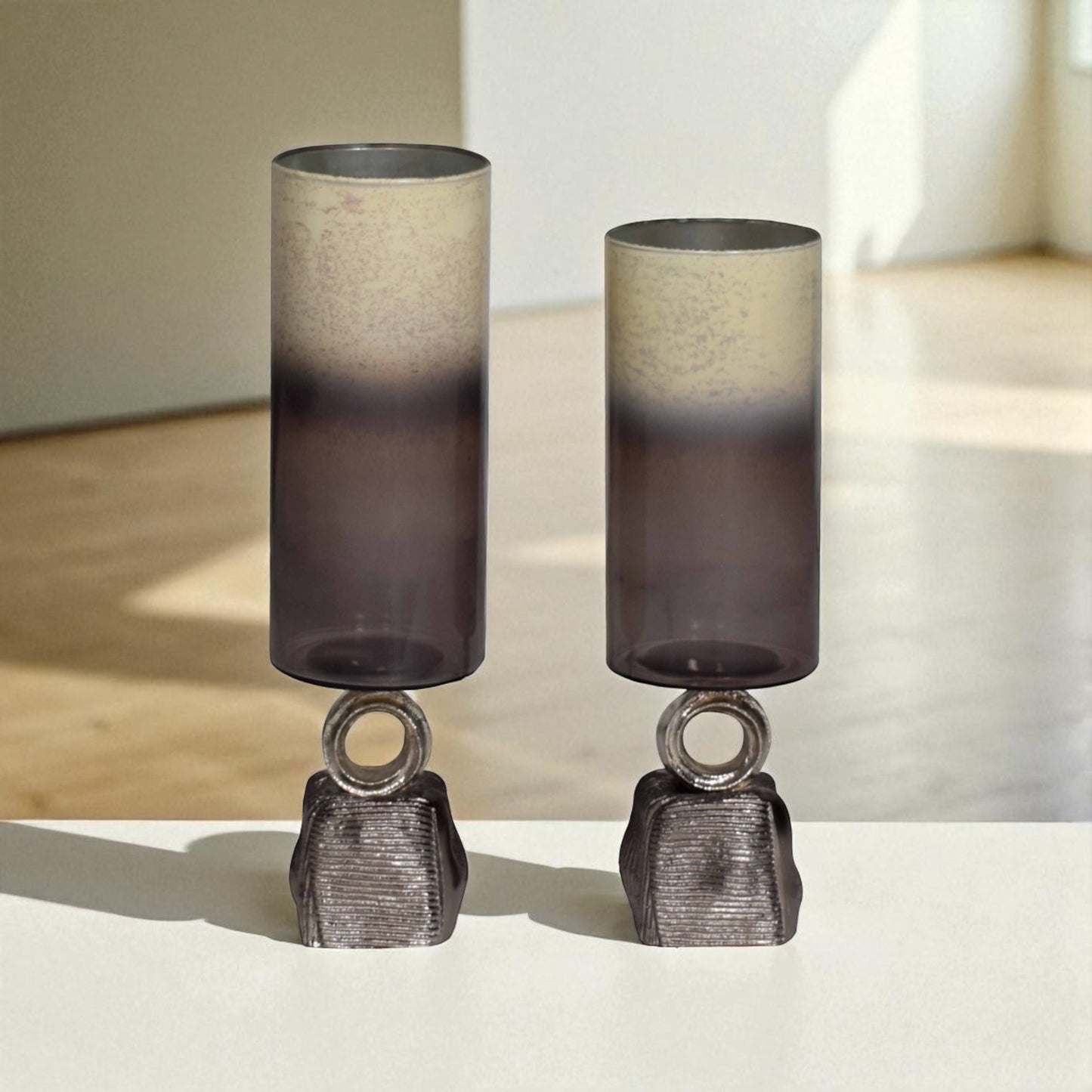 Two cylindrical lamps with gradient shades on a neutral background