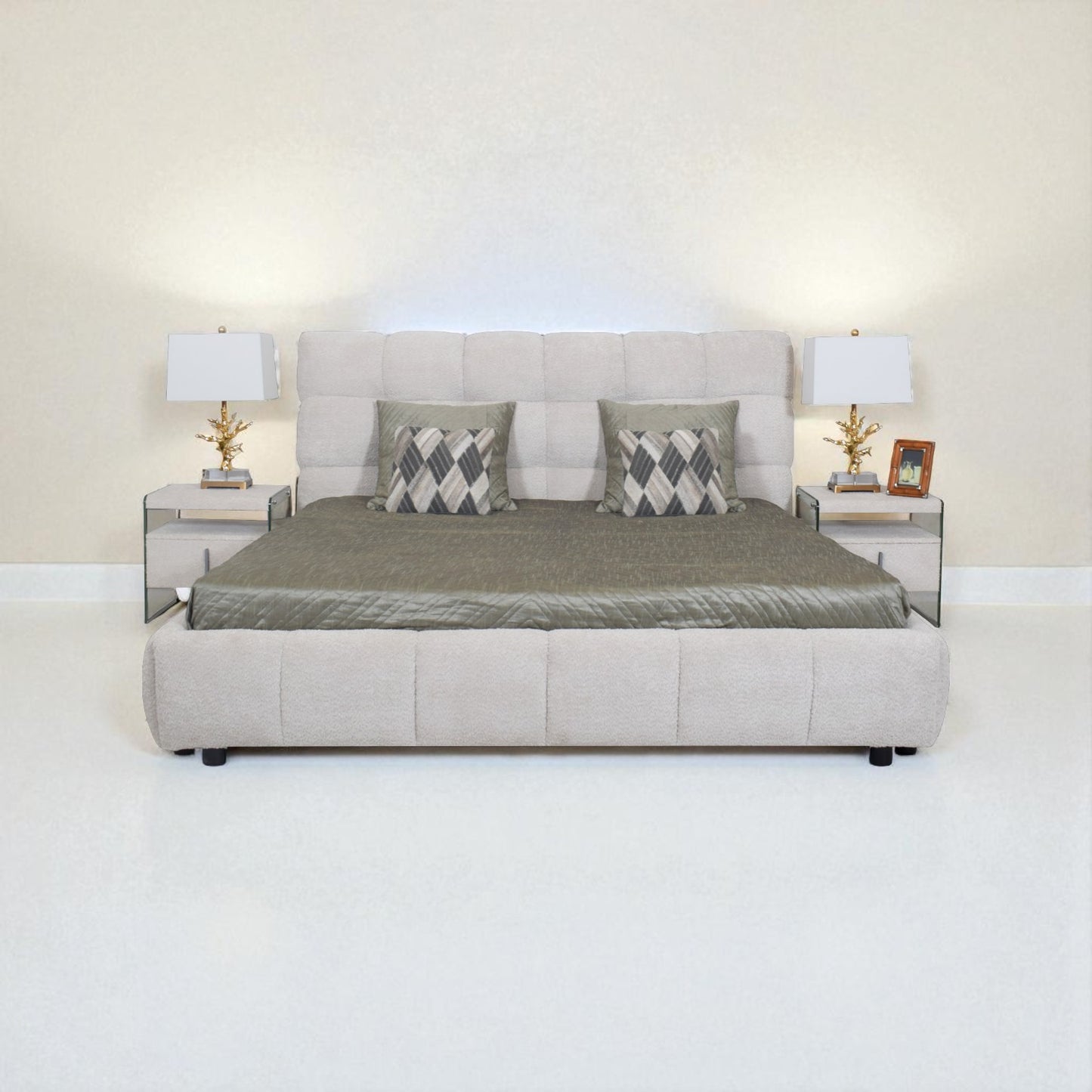Beige upholstered bed with gray bedding and pillows in a minimalistic room.
