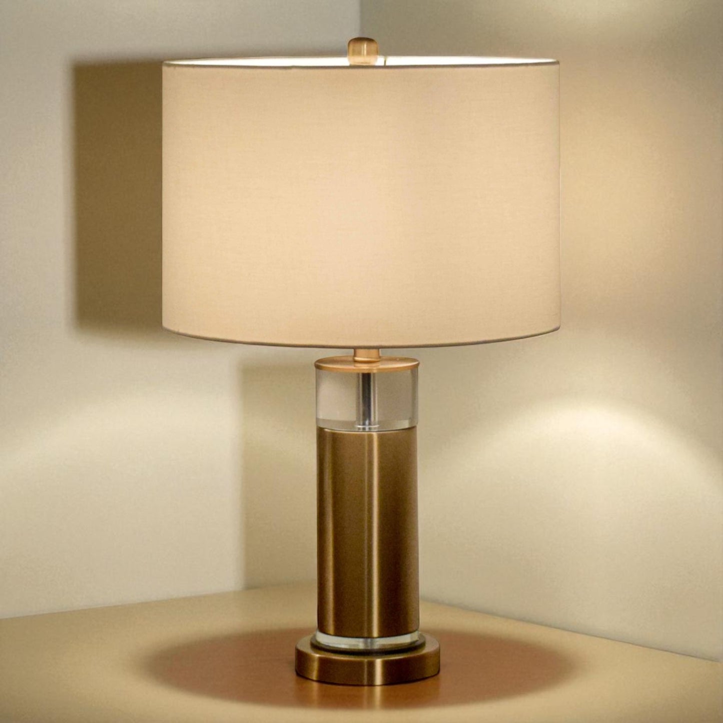 Table lamp with beige shade and bronze base on a neutral background