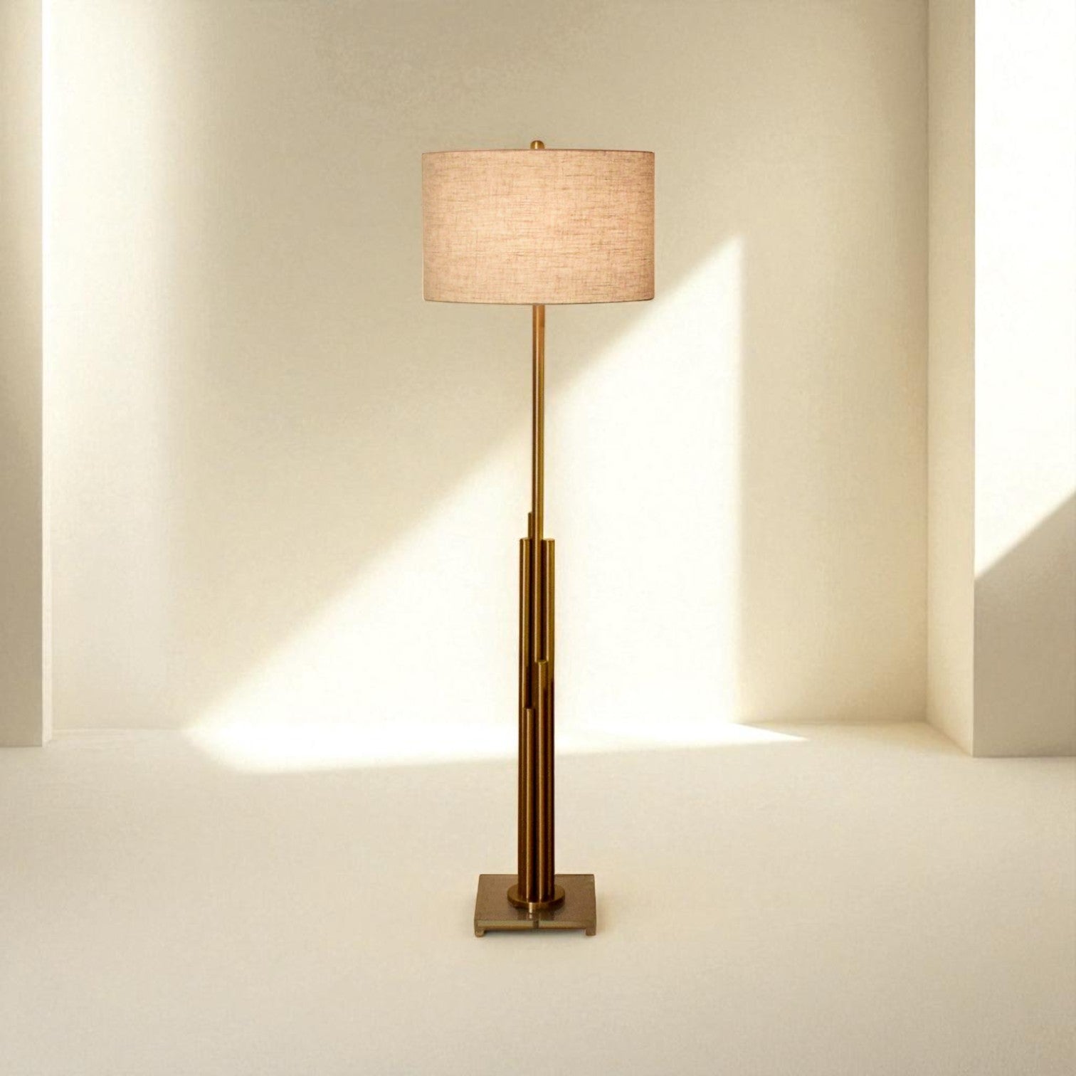 Floor lamp with a beige shade and brass base on a neutral background