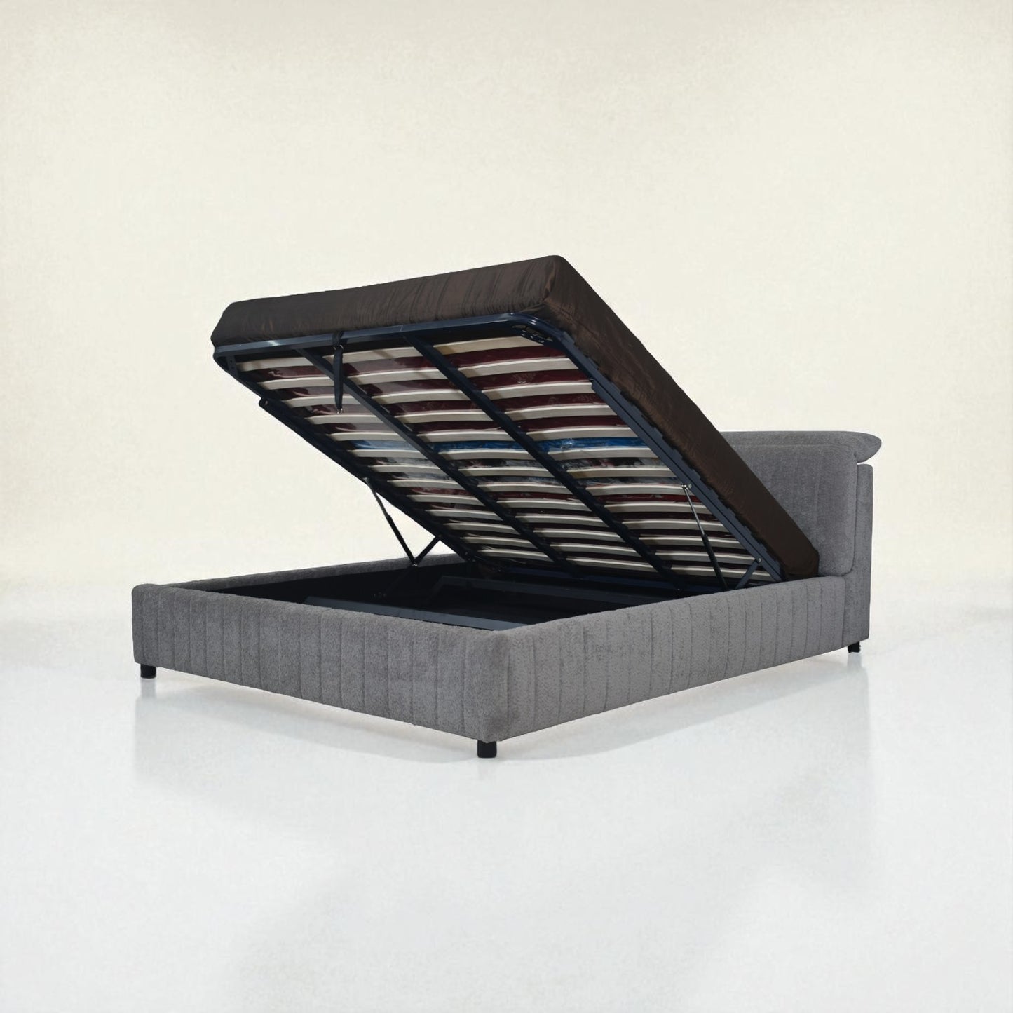 Gray upholstered bed with open headboard on a white background