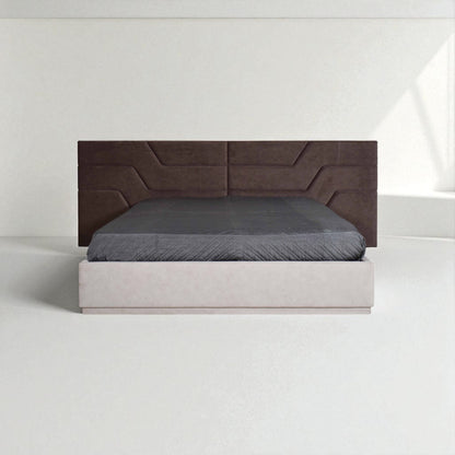 Modern bed with a wide, geometric-patterned brown headboard, light-colored base, and gray bedding in a minimalist white room.