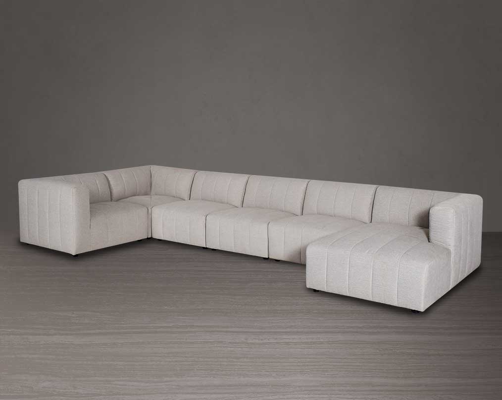 The L shaped modular sofa comes upholstered in regal beige fabric with vertical channel quilting & an ottoman to compliment.