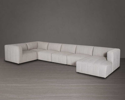 The L shaped modular sofa comes upholstered in regal beige fabric with vertical channel quilting & an ottoman to compliment.