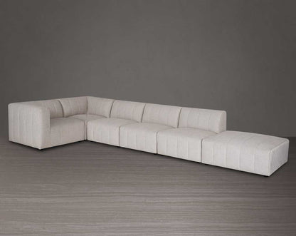 The L shaped modular sofa comes upholstered in regal beige fabric with vertical channel quilting & an ottoman to compliment -  right side