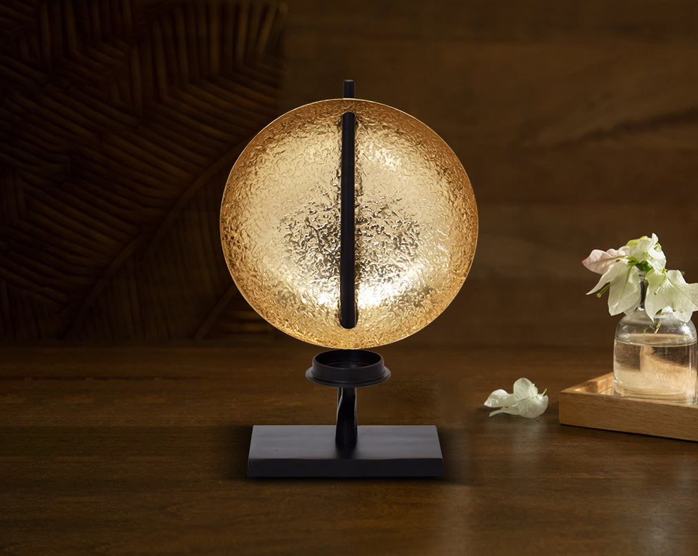 This retro-modern candle/pillar holder is crafted in antique brass with the candle holder in matt black adding a timeless mood to any space with table 