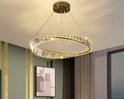 Art deco chandelier with crystal prism fringe adorned with champagne gold metal band evokes the boldness and glamour of the era with living room